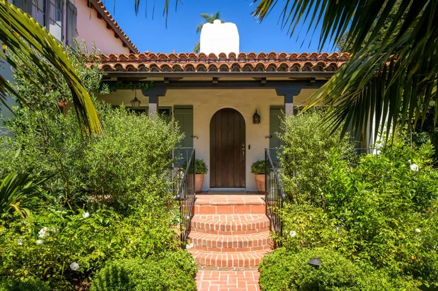 a front view of a house with a garden