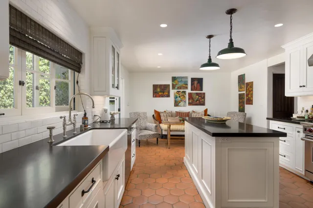 a open kitchen with stainless steel appliances granite countertop a sink a stove and a refrigerator