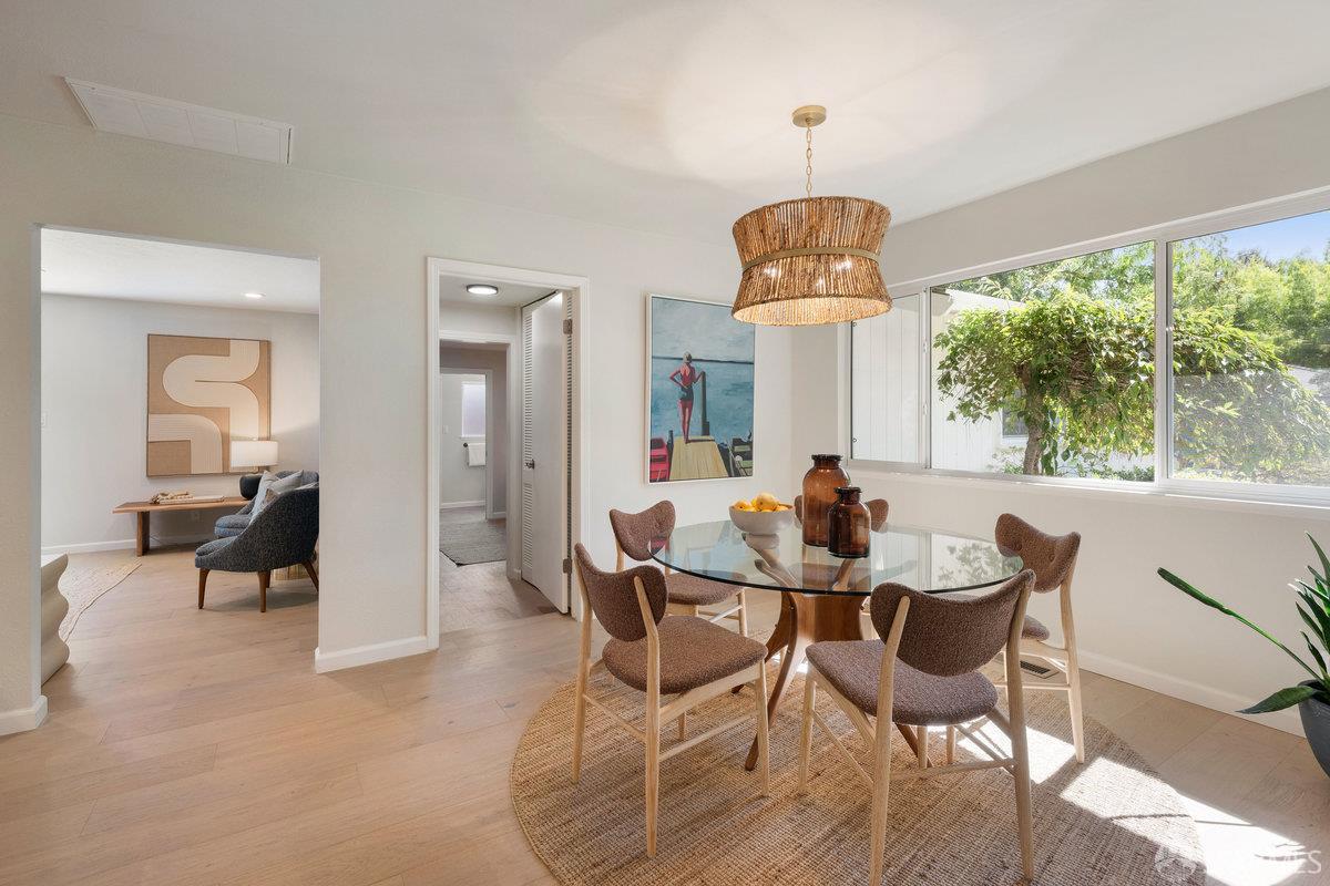 714 Wimbledon Road Walnut Creek, CA 94598 - Photo 16 of 58 a dining room with wooden floor a chandelier a wooden table and chairs