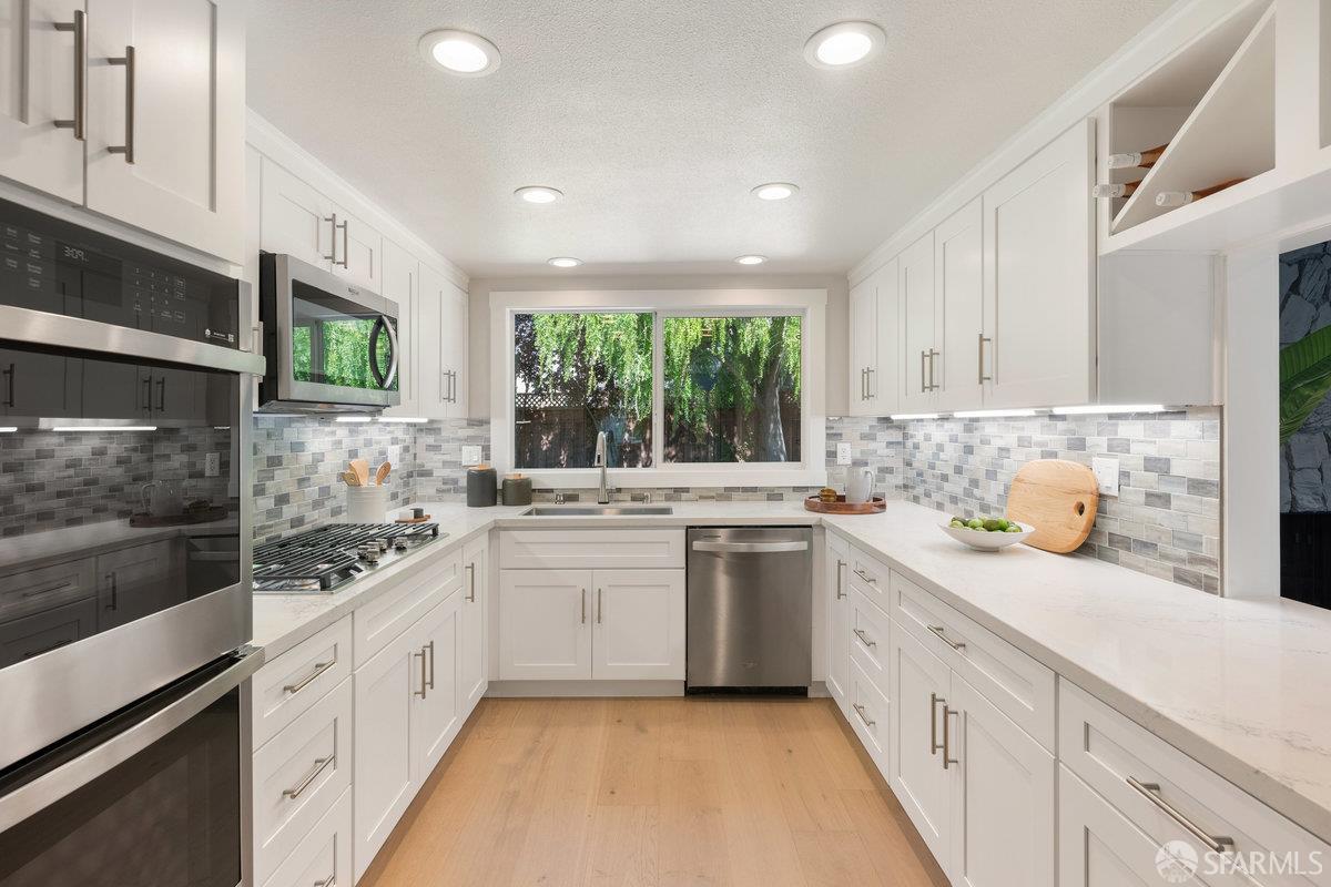 714 Wimbledon Road Walnut Creek, CA 94598 - Photo 17 of 58 a kitchen with stainless steel appliances a stove sink and cabinets