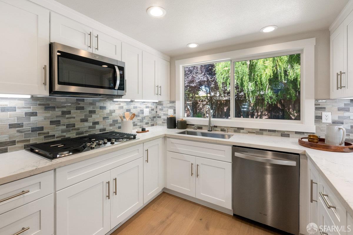 714 Wimbledon Road Walnut Creek, CA 94598 - Photo 18 of 58 a kitchen with stainless steel appliances a sink stove and microwave
