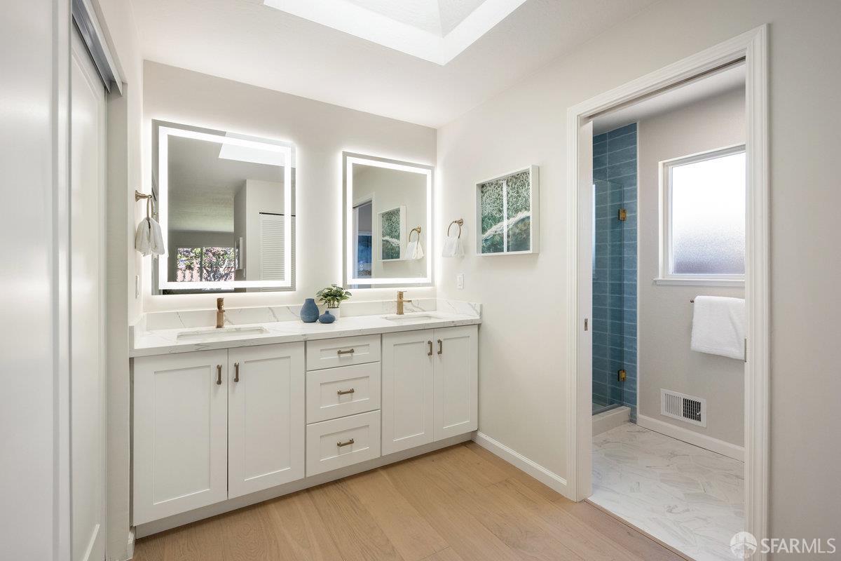 714 Wimbledon Road Walnut Creek, CA 94598 - Photo 25 of 58 a spacious bathroom with a double vanity sink and a mirror
