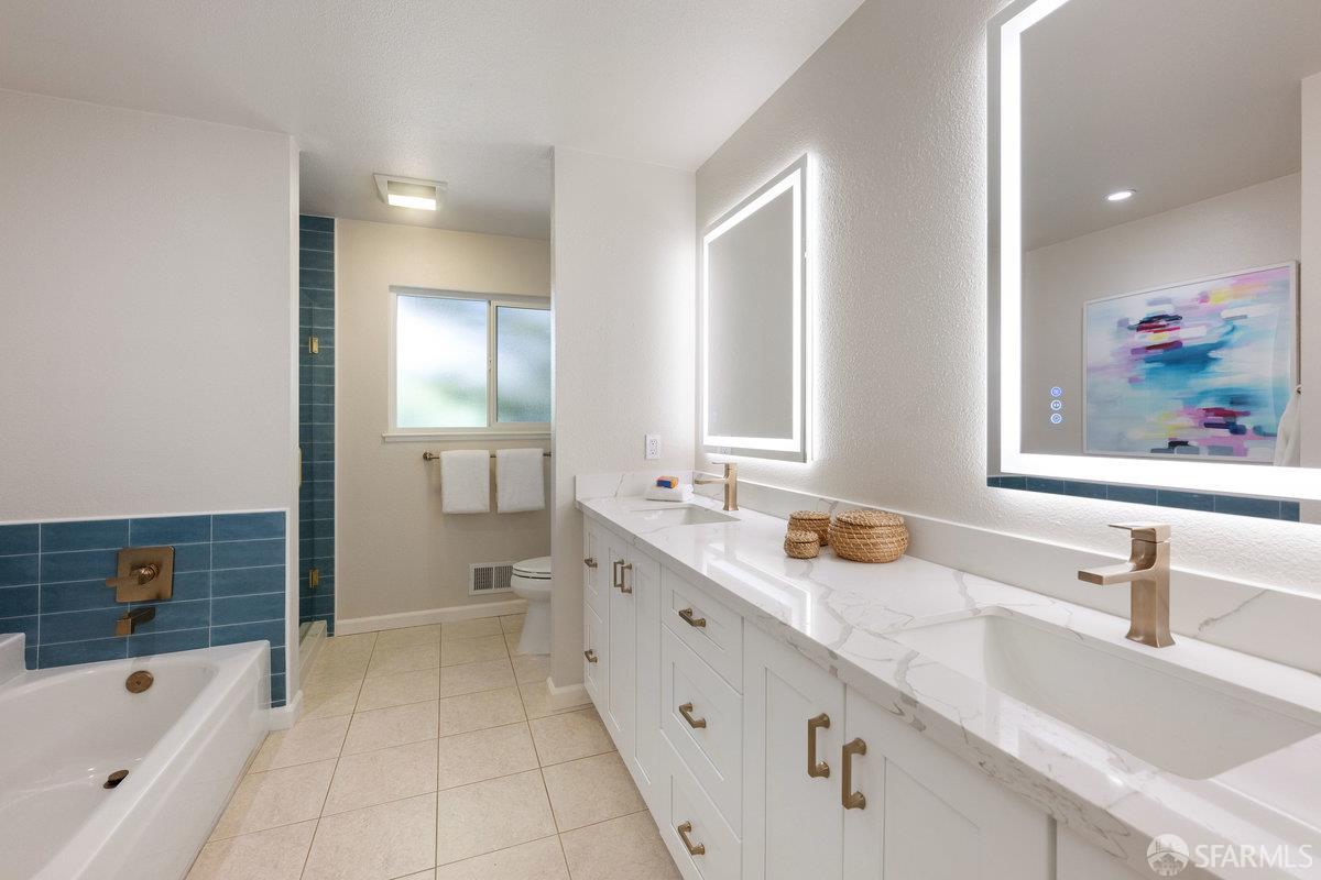 714 Wimbledon Road Walnut Creek, CA 94598 - Photo 32 of 58 a spacious bathroom with a bathtub sink and mirror