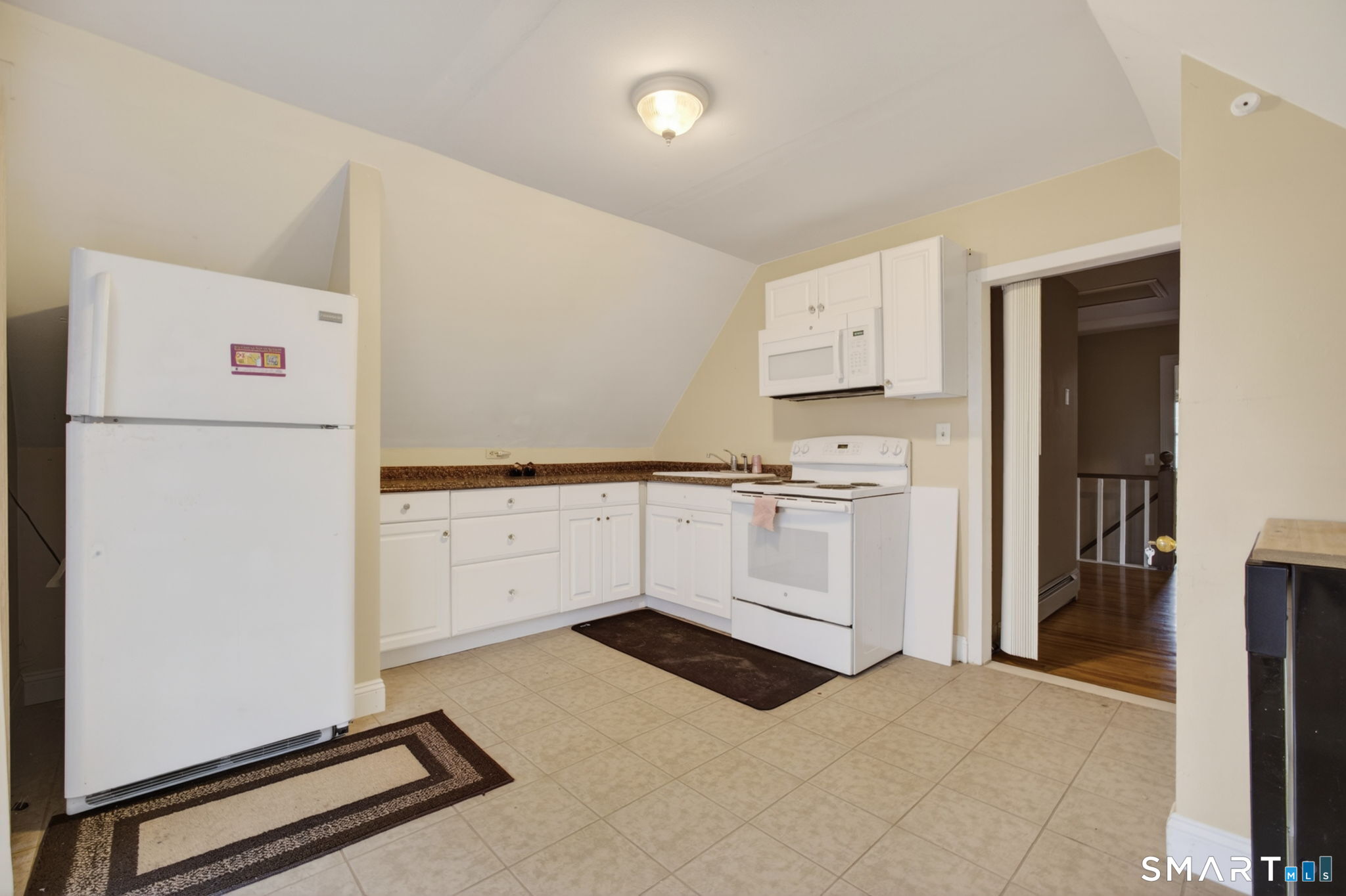 670 Hanover Road Meriden, CT 06451 - Photo 33 of 40 a kitchen with white cabinets and white appliances