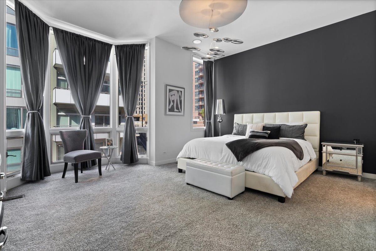 641 West Wayman Street, Unit B Chicago, IL 60661 - Photo 12 of 25 a bedroom with bed and a chandelier