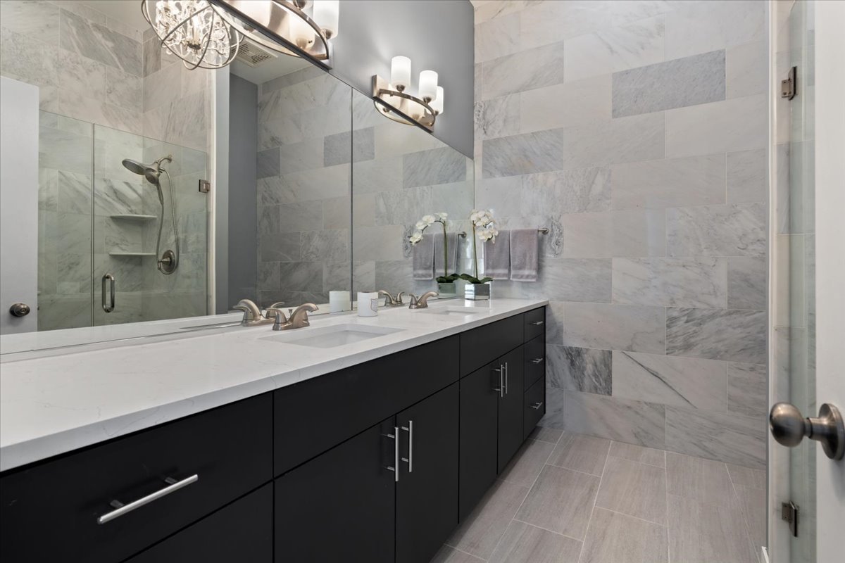 641 West Wayman Street, Unit B Chicago, IL 60661 - Photo 13 of 25 a bathroom with a double vanity sink a toilet and a mirror