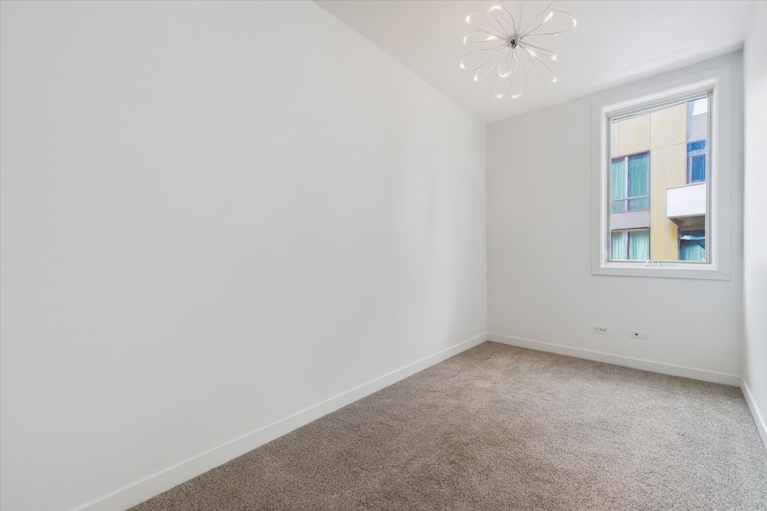 641 West Wayman Street, Unit B Chicago, IL 60661 - Photo 15 of 25 an empty room with a ceiling fan and window