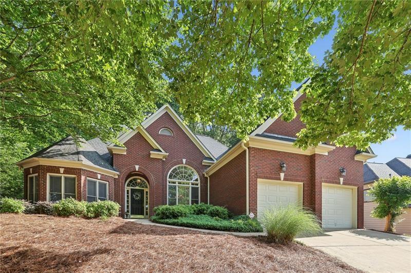 378 Rhodes House Drive Suwanee, GA 30024 - Photo 1 of 1 a front view of a house with a garden