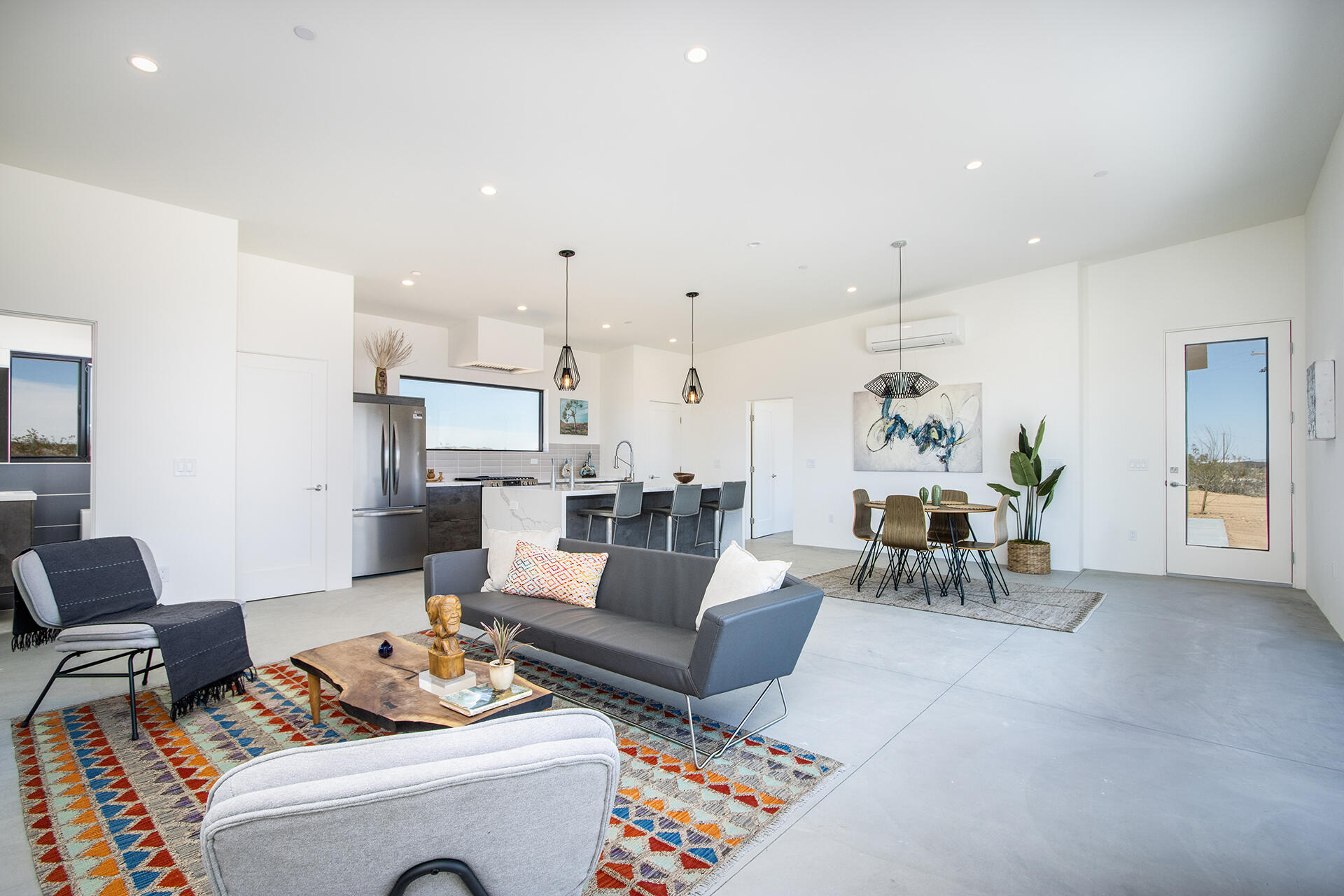 1370 Mc Garry Road Joshua Tree, CA 92252 - Photo 6 of 32 a living room with furniture and a table