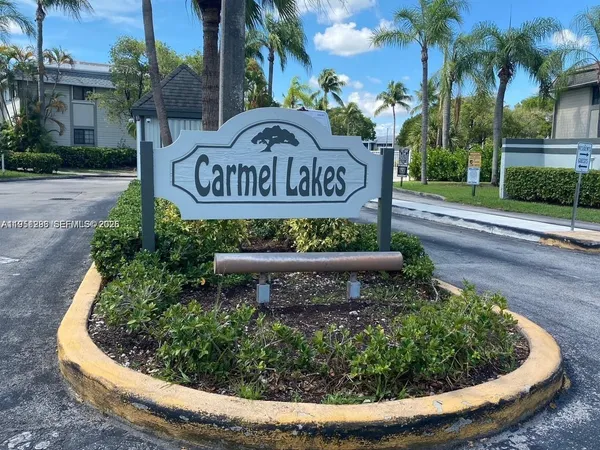 a kitchen with granite countertop white cabinets and stainless steel appliances