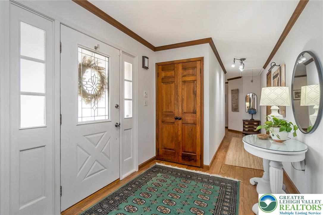 540 Briar Road Pen Argyl, PA 18072 - Photo 8 of 66 Enter a welcoming space with warm hardwood floors and a bright entry door featuring decorative glass.