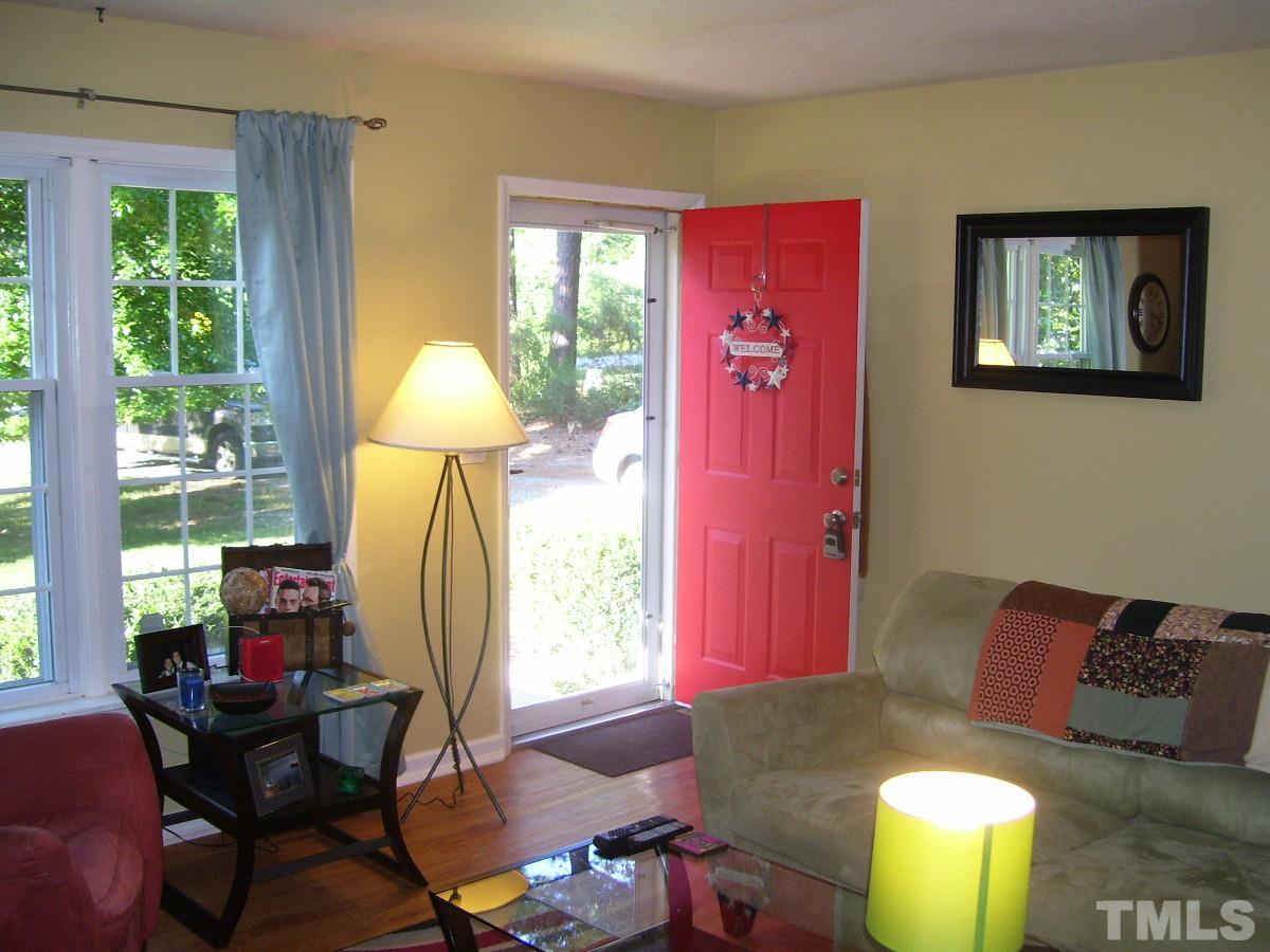 2153 Winkler Road Durham, NC 27712 - Photo 2 of 21 a living room with furniture and a chandelier