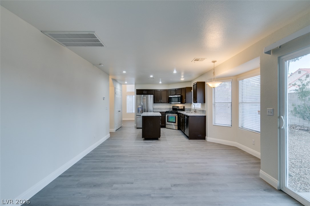 1738 Toltec Circle Henderson, NV 89014 - Photo 46 of 46 An open floorplan connecting a well-equipped kitchen to a versatile living space.