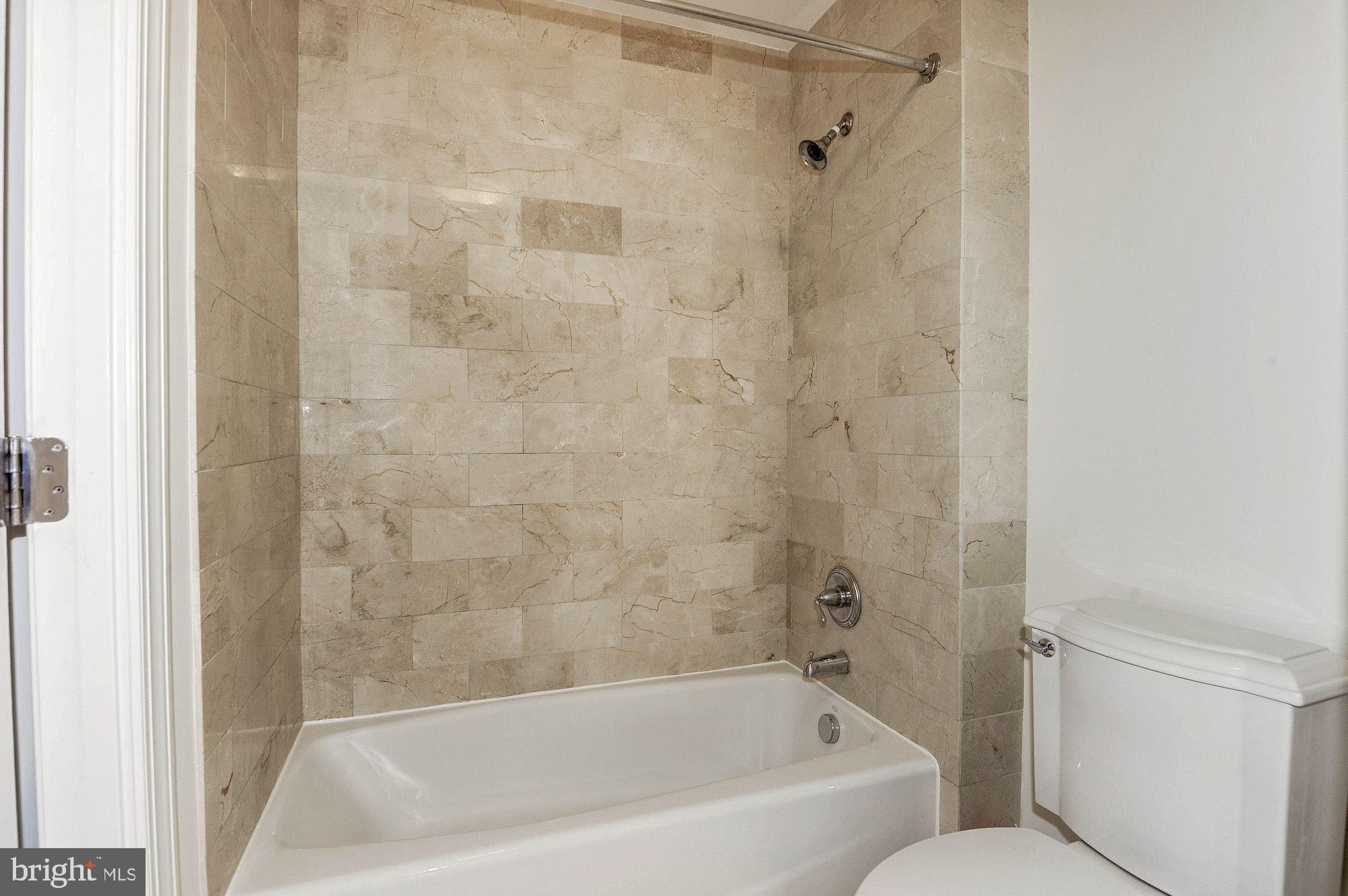 2425 L Street Northwest, Unit 635 Washington, DC 20037 - Photo 13 of 38 Full tub/shower w marble surround