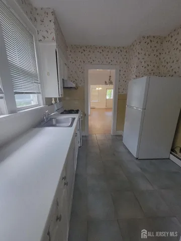 a en suite bathroom with a granite countertop sink and a mirror
