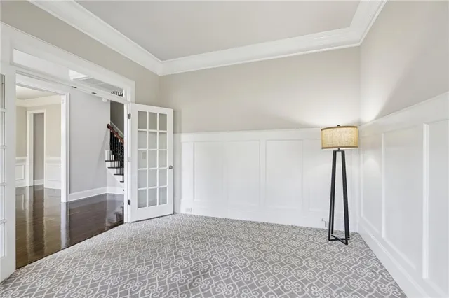 a view of an empty room with wooden floor fireplace and a window