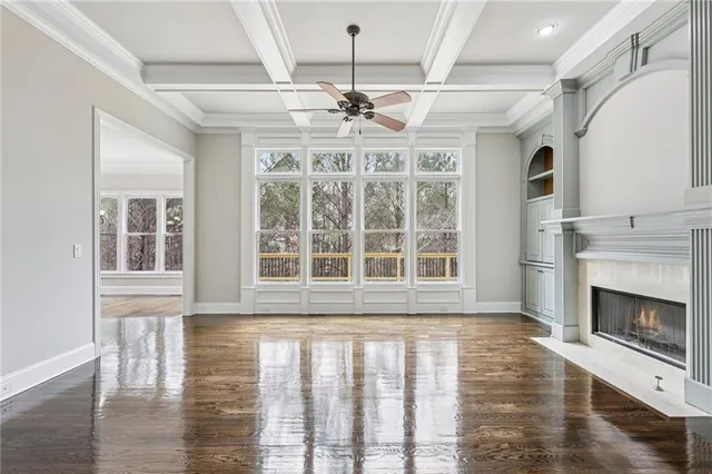 a view of a livingroom with wooden floor and a ceiling fan