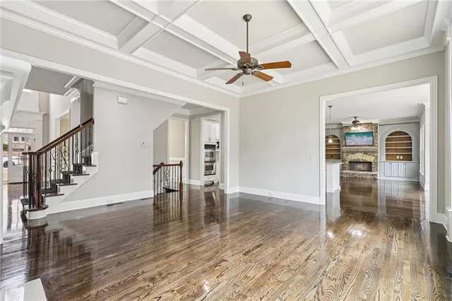 a kitchen with kitchen island a stove a refrigerator a sink and a wooden floor