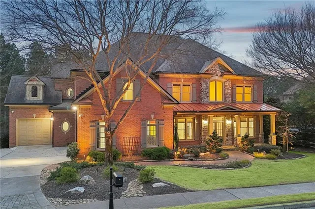 a front view of a house with yard and green space