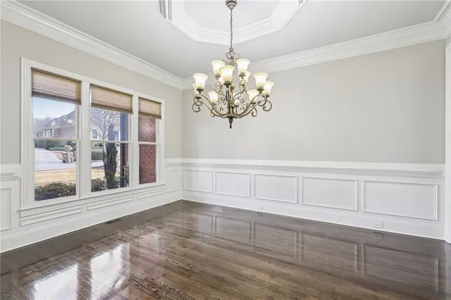 a view of a chandelier fan and wooden floor