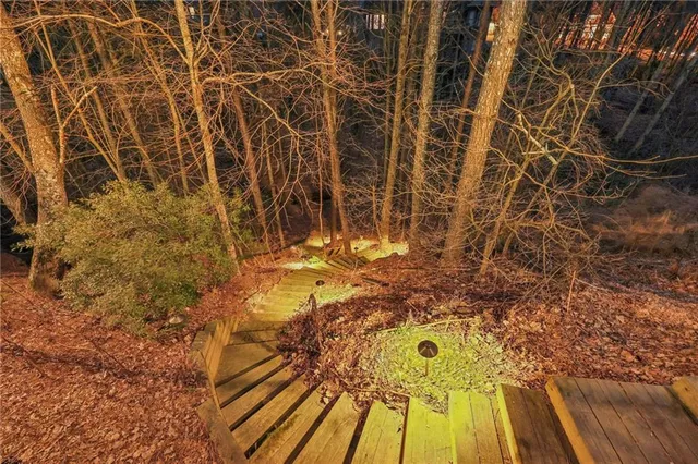 a view of backyard with deck and wooden floor