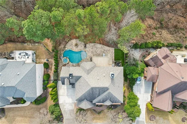 an aerial view of a house with swimming pool and outdoor seating