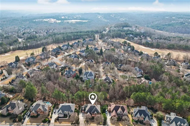 an aerial view of residential houses with outdoor space and parking
