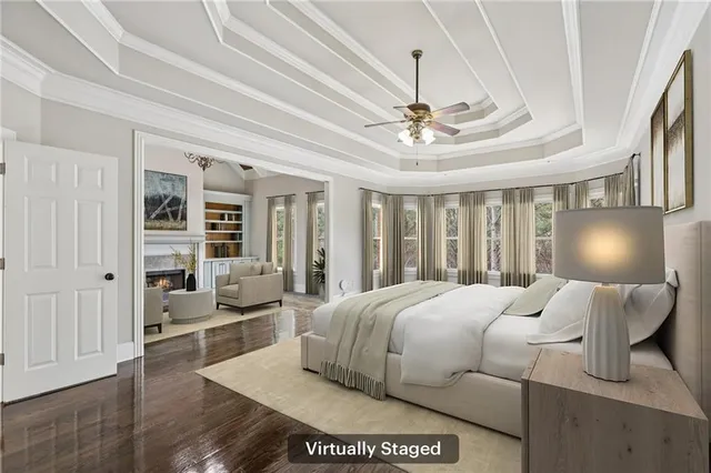 a bedroom with a large bed and a chandelier