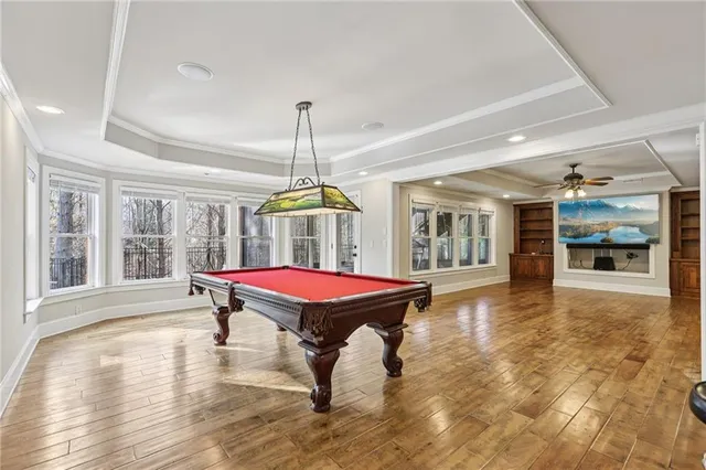 a dining room with furniture window and wooden floor
