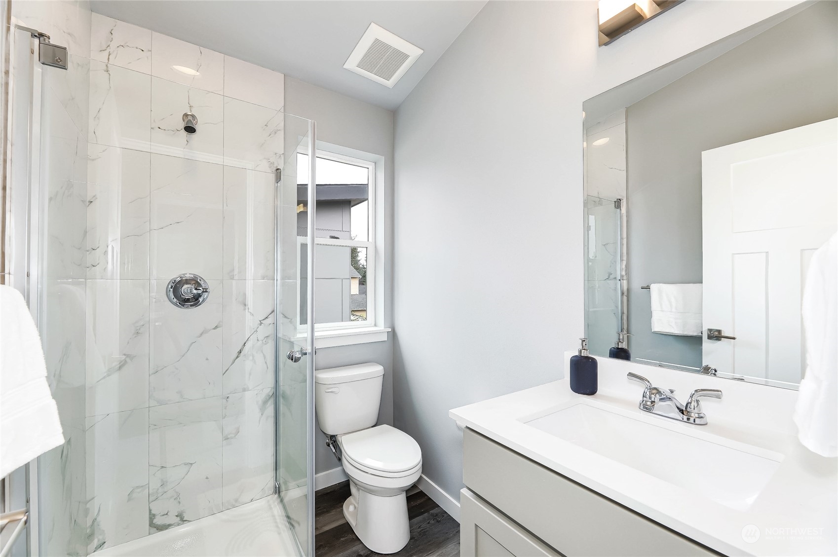 846 Southwest 136th Street, Unit 1 Burien, WA 98166 - Photo 13 of 18 a bathroom with a sink toilet a mirror and shower