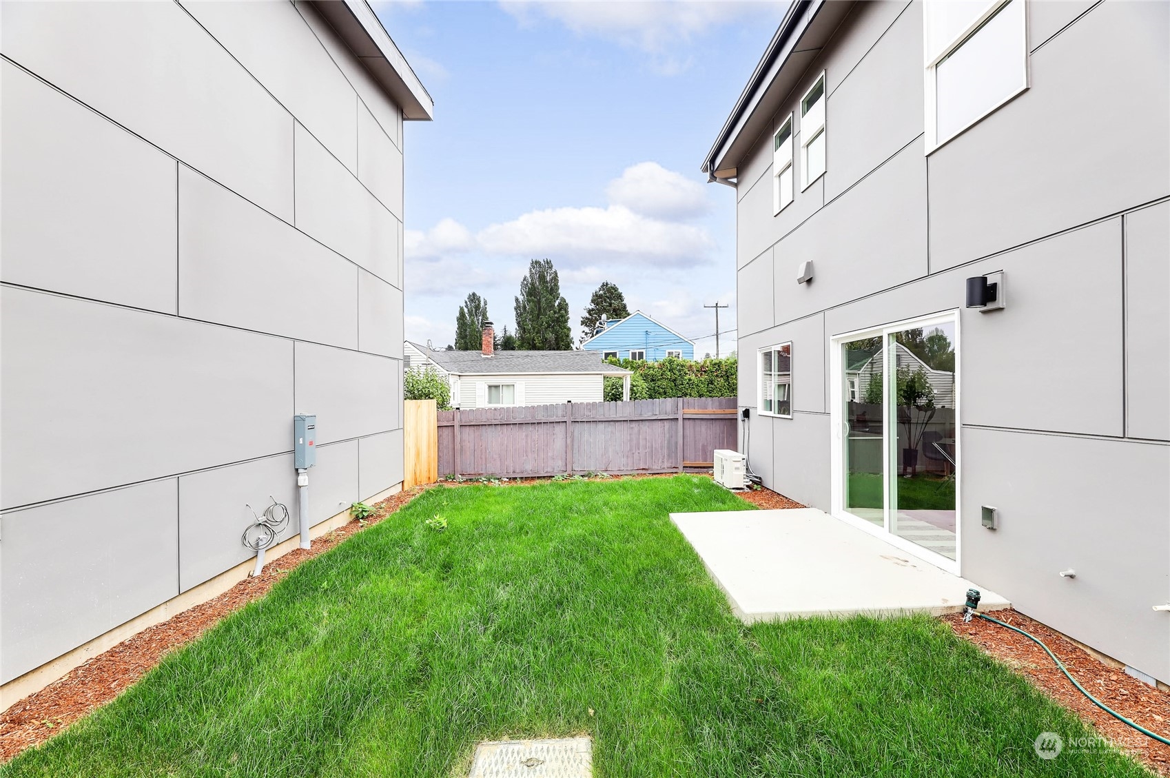 846 Southwest 136th Street, Unit 1 Burien, WA 98166 - Photo 17 of 18 a view of a backyard with plants and brick walls