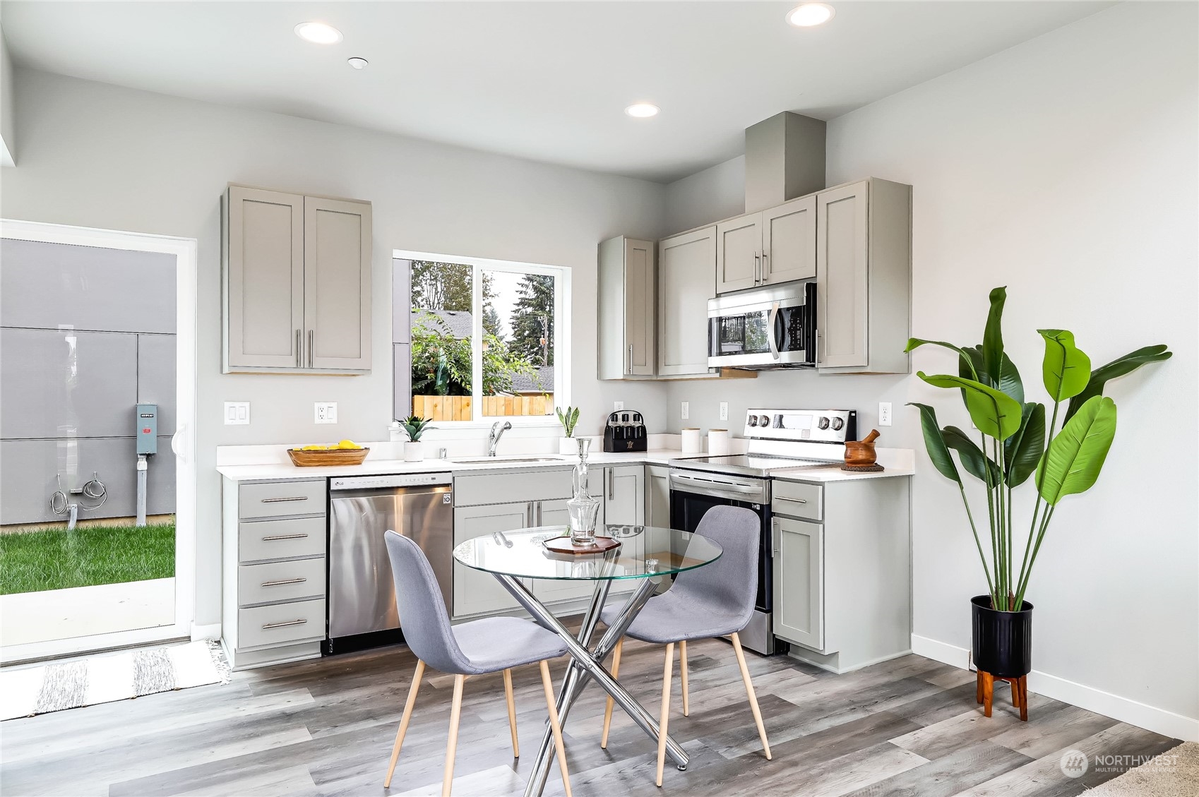 846 Southwest 136th Street, Unit 1 Burien, WA 98166 - Photo 8 of 18 a kitchen with a table and chairs in it