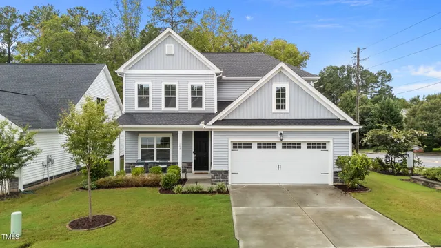 a front view of a house with a yard garage and outdoor seating