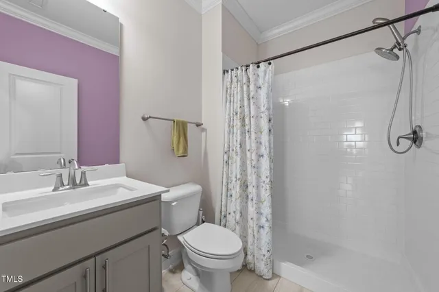 a bathroom with a double vanity sink a large mirror and a bathtub