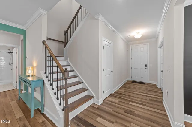 a view of a hallway with wooden floor and entryway