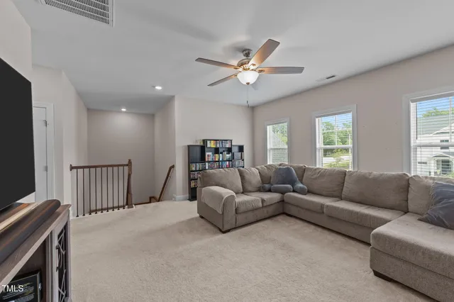 a bedroom with a bed and painting on the wall