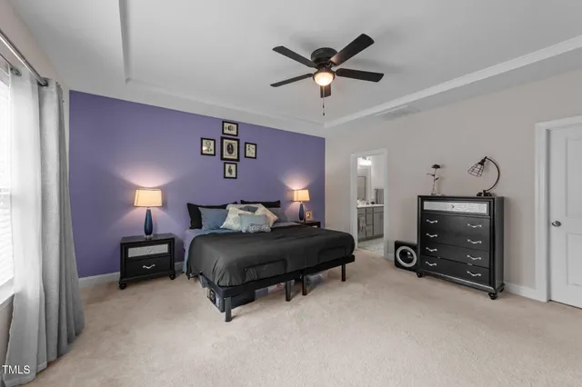 a bedroom with a large bed and a flat screen tv