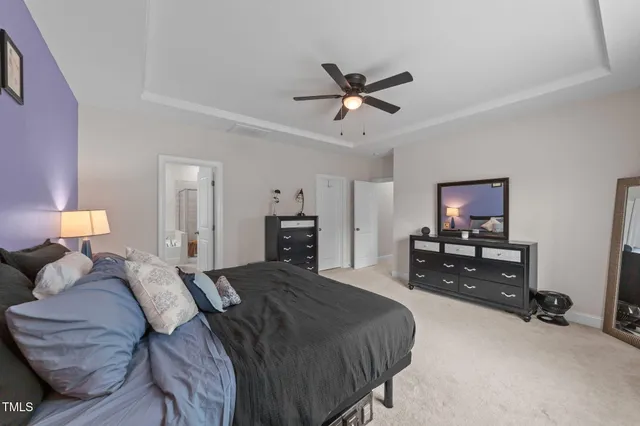 a view of house with garden space and trees in the background