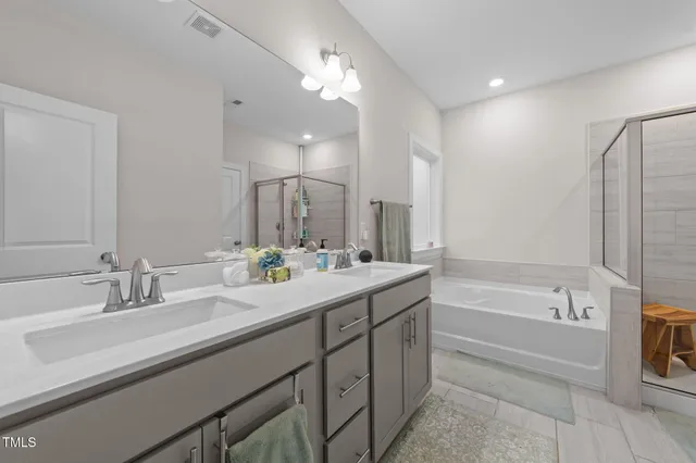 a house with a lot of flower plants in front of door