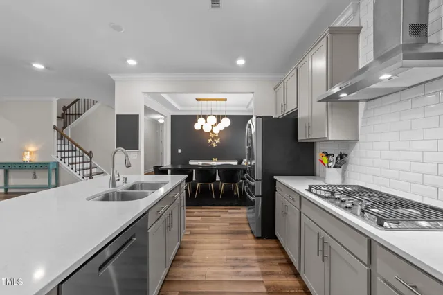 a view of a livingroom with furniture wooden floor and staircase