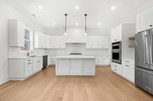 a kitchen with cabinets appliances and a counter space