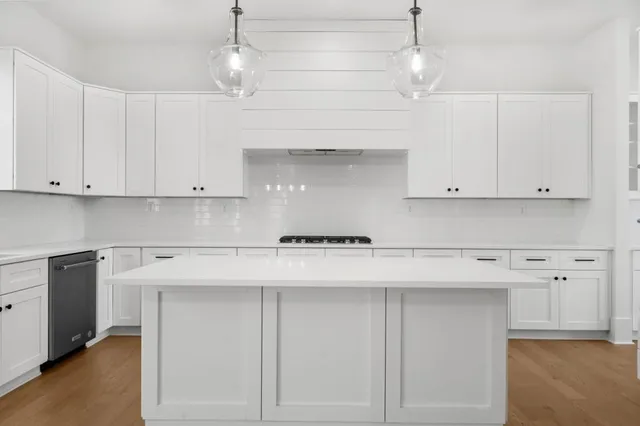 a kitchen with stainless steel appliances a refrigerator sink and stove
