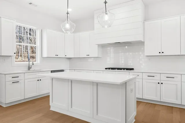a kitchen with cabinets and stainless steel appliances