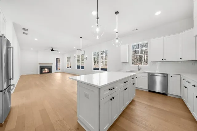 a view of an empty room with a fireplace and a window