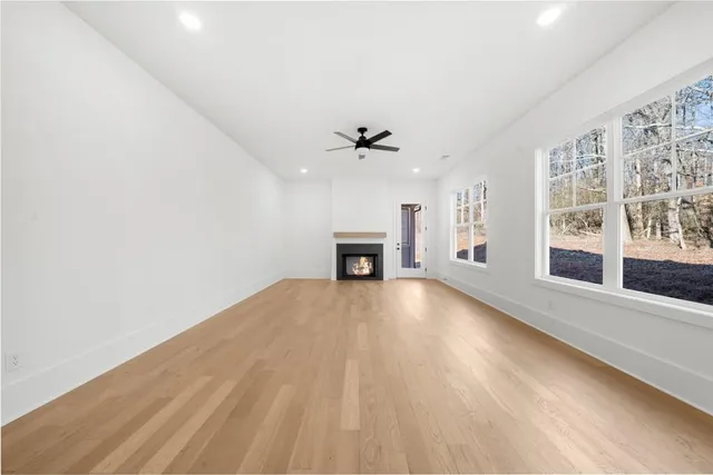 a view of a livingroom with a ceiling fan and window