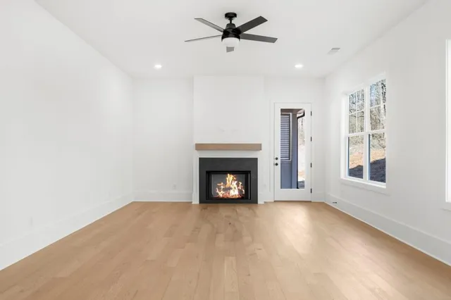 an empty room with a window and a ceiling fan