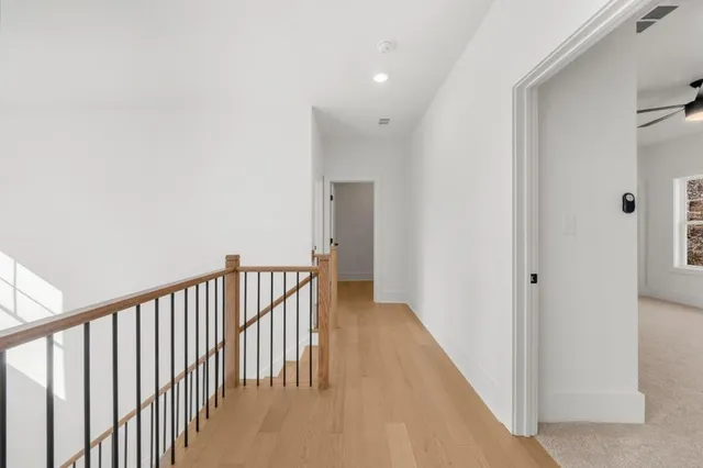 a spacious bathroom with a double vanity sink a mirror and a shower