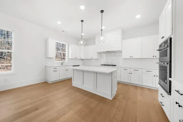 a kitchen with stainless steel appliances a stove a refrigerator and a sink