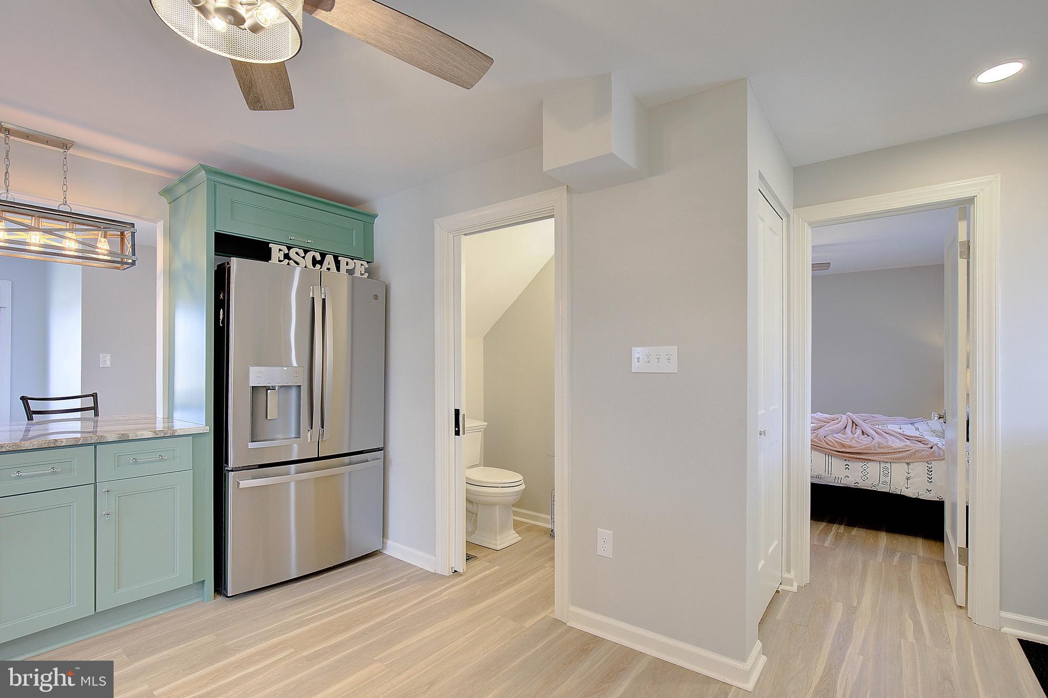 20938 Olen Mattingly Road Avenue, MD 20609 - Photo 11 of 47 a kitchen with a refrigerator and a view of living room