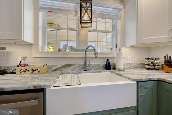 a kitchen with a sink a stove and cabinets